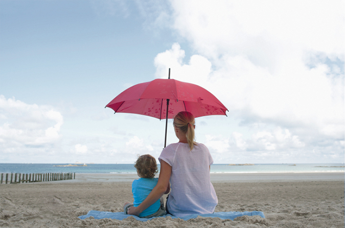 a mother and child on the beach